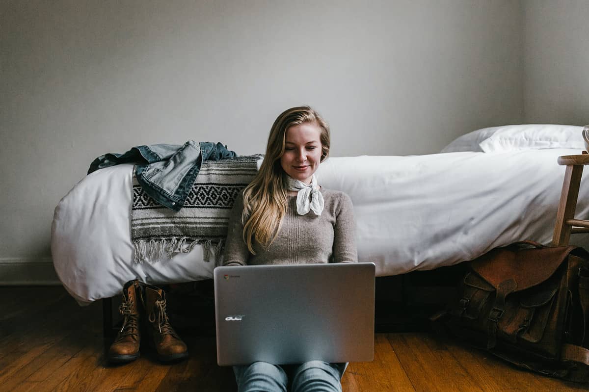 A girl writing short stories on her laptop.