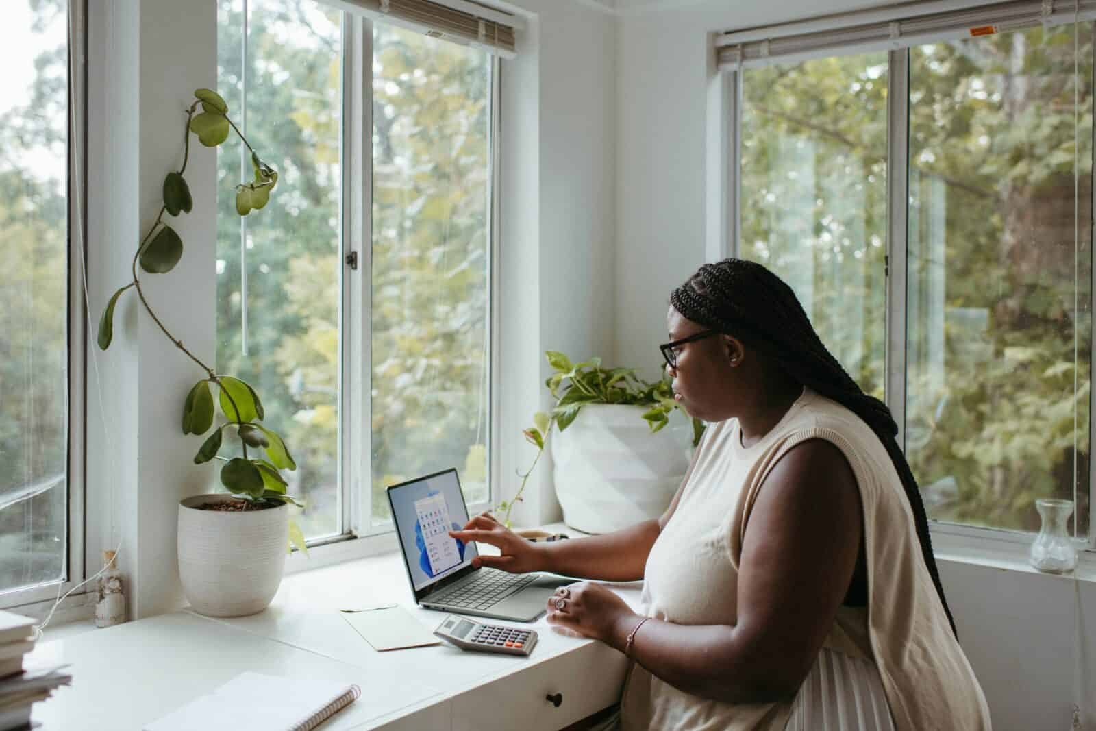 Low Stress Jobs After Retirement Remote – Simple And Peaceful Jobs Photo - 5 A Woman Sitting At A Table With A Laptop