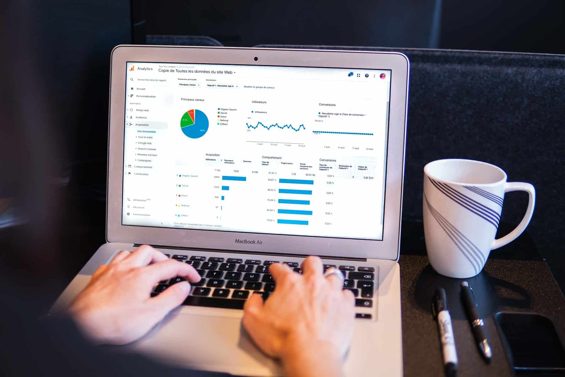 Person Using Macbook Pro On Black Table