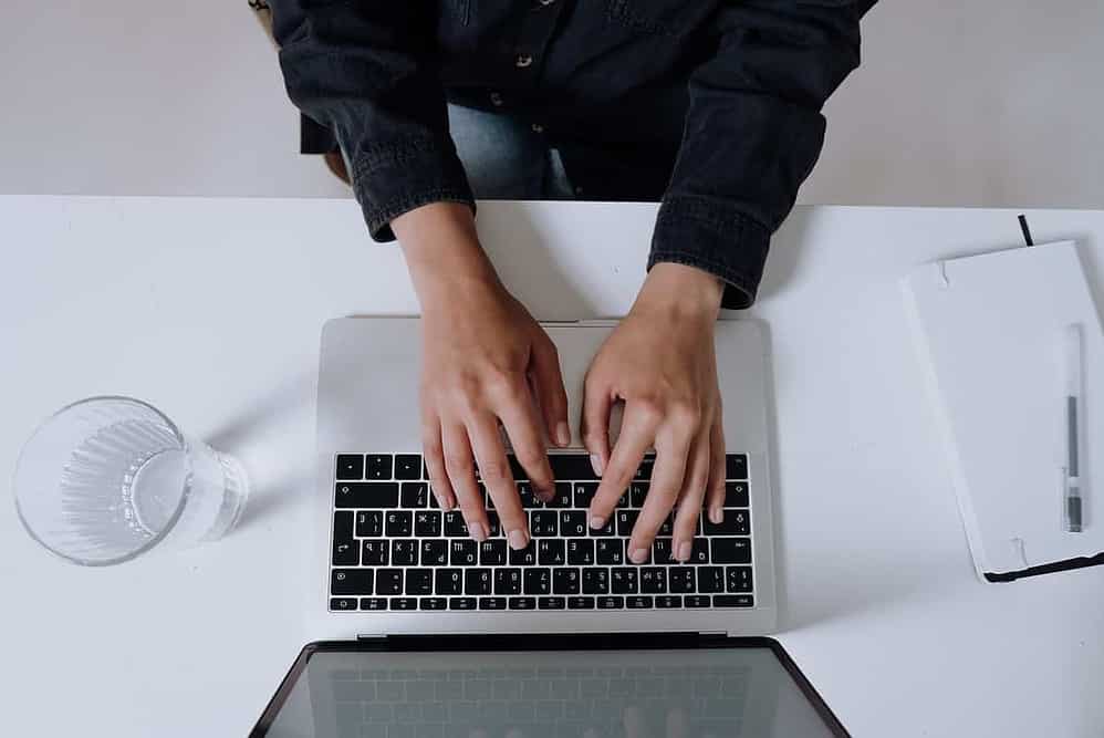 Free Person In Black Long Sleeve Shirt Using Macbook Pro Stock Photo